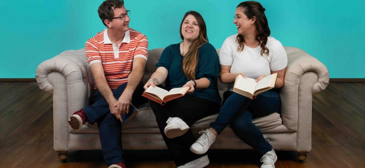 Three people sharing a conversation on a sofa, pictured in Inflectiv’s sixth-anniversary post.