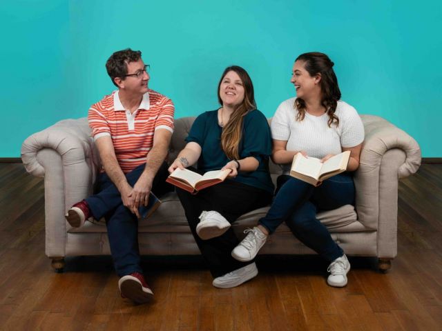 Three people sharing a conversation on a sofa, pictured in Inflectiv’s sixth-anniversary post.